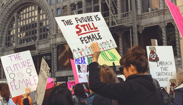 Frauen demonstrieren mit Schildern auf denen unter anderem steht: The future is still female