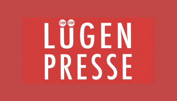 Auf rotem Untergrund ist das Wort Lügenpresse in großen Lettern geschrieben. Die beiden Punkte auf dem ü sind Stoppschilder.